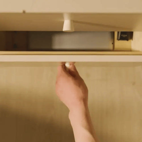 A hand reaching into a cluttered drawer to pull out an old idle iPad, illustrating the common waste of technology before repurposing with iFramix.